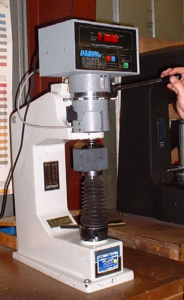 A person using a machine to press the button.
