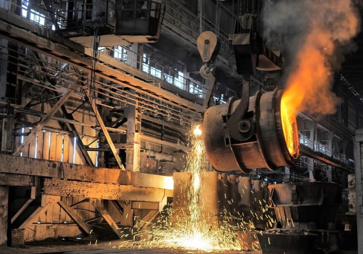 A large metal mill with a bright flame coming out of it.